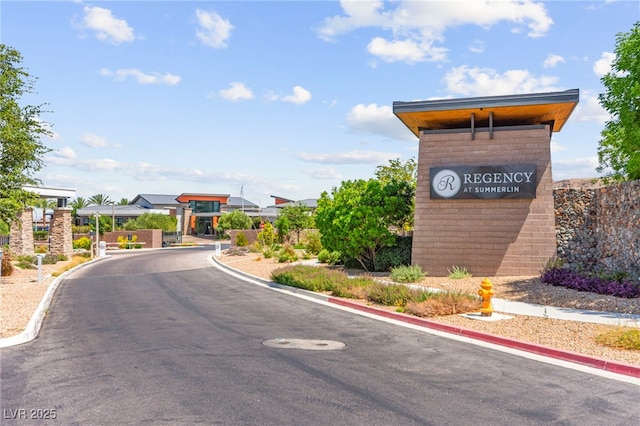 6810 Silver Crescent St, Las Vegas, NV 89148 - view of asphalt street featuring curbs and a gated entry