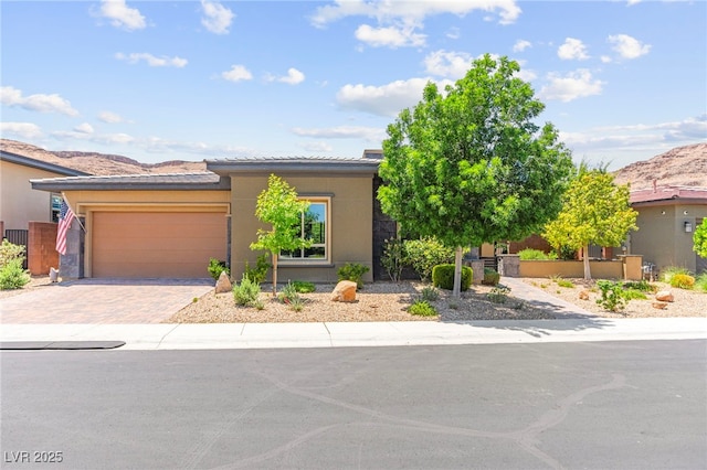 6810 Silver Crescent St, Las Vegas, NV 89148 - view of front of home with a garage, driveway, stucco siding, and a mountain view
