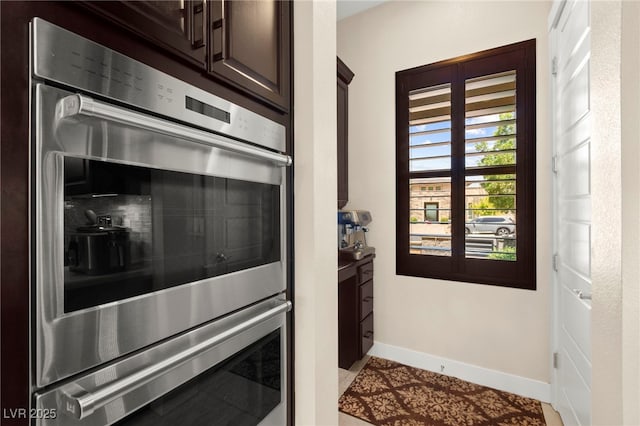 6810 Silver Crescent St, Las Vegas, NV 89148 - kitchen with stainless steel double oven, dark brown cabinets, and decorative backsplash