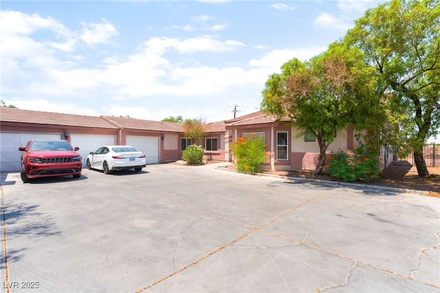 4656 E Desert Inn Rd, Las Vegas, NV 89121 - view of front of property featuring concrete driveway, a garage, and stucco siding