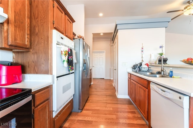 4656 E Desert Inn Rd, Las Vegas, NV 89121 - kitchen with white dishwasher, fridge, stainless steel refrigerator with ice dispenser, light countertops, and brown cabinets