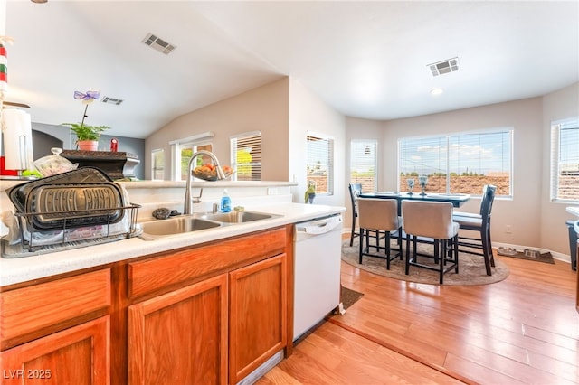 4656 E Desert Inn Rd, Las Vegas, NV 89121 - kitchen with white dishwasher, light countertops, light wood finished floors, recessed lighting, and lofted ceiling