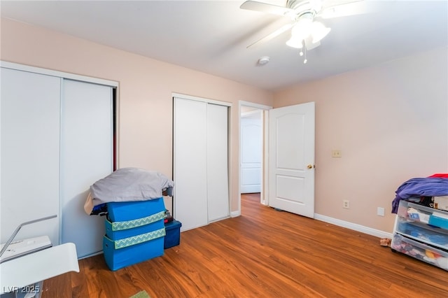 4656 E Desert Inn Rd, Las Vegas, NV 89121 - bedroom featuring two closets, wood finished floors, and a ceiling fan