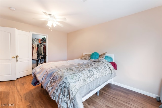 4656 E Desert Inn Rd, Las Vegas, NV 89121 - bedroom featuring wood finished floors, a closet, a spacious closet, and a ceiling fan