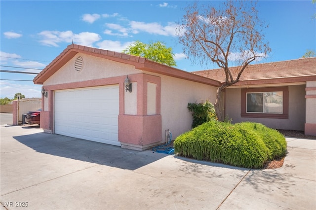 4656 E Desert Inn Rd, Las Vegas, NV 89121 - view of property exterior with stucco siding, driveway, and a tile roof