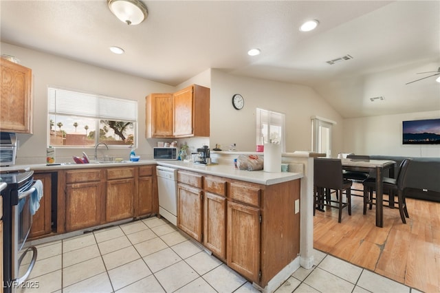 4656 E Desert Inn Rd, Las Vegas, NV 89121 - kitchen featuring white dishwasher, open floor plan, a peninsula, stainless steel electric range oven, and light tile patterned floors