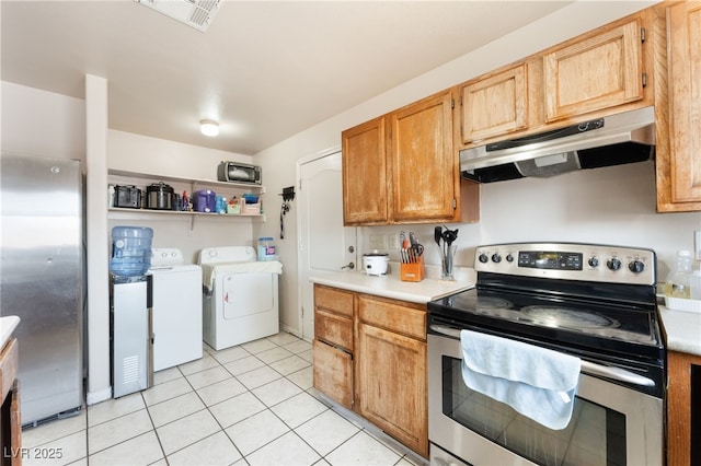 4656 E Desert Inn Rd, Las Vegas, NV 89121 - kitchen featuring stainless steel appliances, under cabinet range hood, washer and clothes dryer, light countertops, and light tile patterned flooring