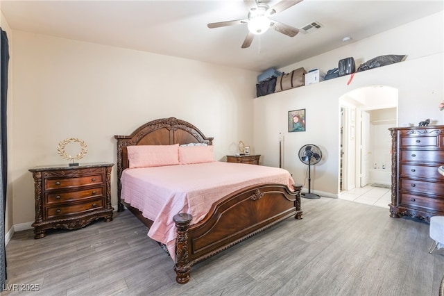 4656 E Desert Inn Rd, Las Vegas, NV 89121 - bedroom with arched walkways, wood finished floors, ceiling fan, and ensuite bathroom