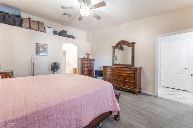 4656 E Desert Inn Rd, Las Vegas, NV 89121 - bedroom featuring wood finished floors, arched walkways, a ceiling fan, and ensuite bathroom