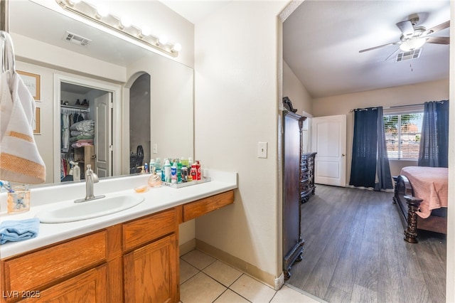 4656 E Desert Inn Rd, Las Vegas, NV 89121 - bathroom with vanity, ceiling fan, and a walk in closet