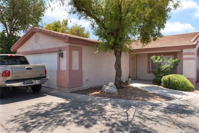 4656 E Desert Inn Rd, Las Vegas, NV 89121 - ranch-style house with an attached garage, stucco siding, concrete driveway, and a tile roof