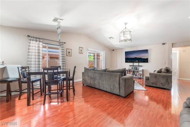 4656 E Desert Inn Rd, Las Vegas, NV 89121 - living room with lofted ceiling, a chandelier, and wood finished floors