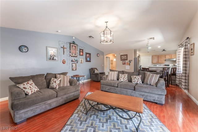 4656 E Desert Inn Rd, Las Vegas, NV 89121 - living area with arched walkways, wood finished floors, a chandelier, and lofted ceiling