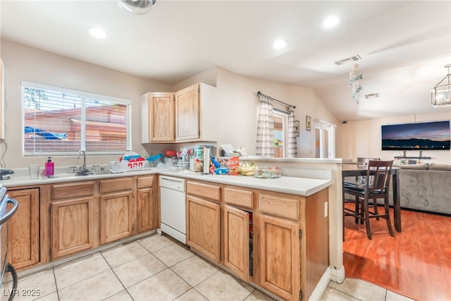 4656 E Desert Inn Rd, Las Vegas, NV 89121 - kitchen featuring dishwasher, a peninsula, open floor plan, light tile patterned floors, and vaulted ceiling
