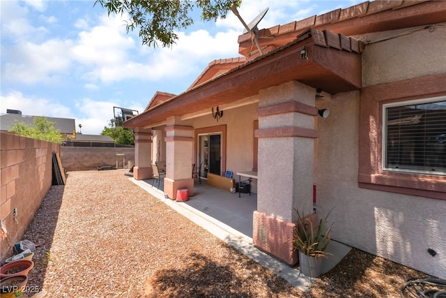 4656 E Desert Inn Rd, Las Vegas, NV 89121 - view of side of home featuring stucco siding, a fenced backyard, and a patio area