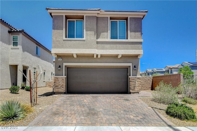 4240 Spring Storm Ave, North Las Vegas, NV 89081 - view of front of property featuring stucco siding, an attached garage, and decorative driveway