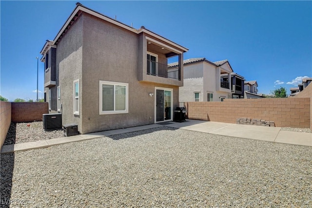 4240 Spring Storm Ave, North Las Vegas, NV 89081 - rear view of property with a fenced backyard, stucco siding, a balcony, and a patio area