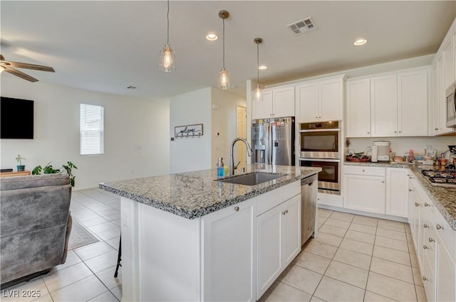 4240 Spring Storm Ave, North Las Vegas, NV 89081 - kitchen featuring stainless steel appliances, open floor plan, light tile patterned floors, ceiling fan, and recessed lighting