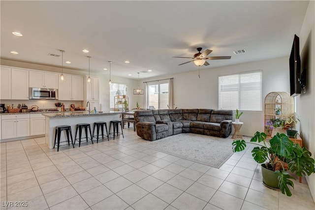 4240 Spring Storm Ave, North Las Vegas, NV 89081 - living room with light tile patterned floors, a ceiling fan, and recessed lighting