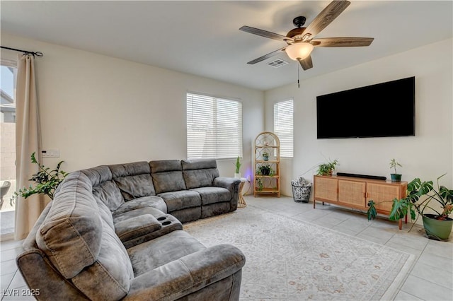 4240 Spring Storm Ave, North Las Vegas, NV 89081 - living area with light tile patterned floors, ceiling fan, and healthy amount of natural light