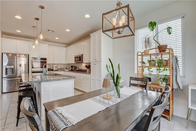 4240 Spring Storm Ave, North Las Vegas, NV 89081 - dining area with light tile patterned floors, a chandelier, and recessed lighting