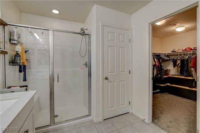 4240 Spring Storm Ave, North Las Vegas, NV 89081 - full bath with a stall shower, tile patterned flooring, a walk in closet, vanity, and recessed lighting