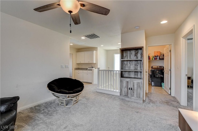 4240 Spring Storm Ave, North Las Vegas, NV 89081 - sitting room featuring light colored carpet, washer / dryer, an upstairs landing, a ceiling fan, and recessed lighting