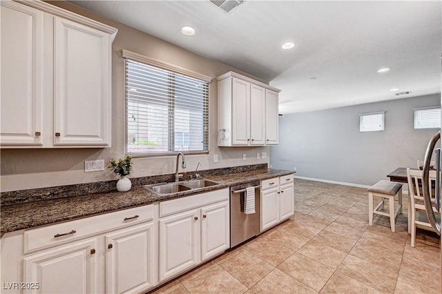7704 Lots Hills Dr, Las Vegas, NV 89179 - kitchen with stainless steel dishwasher, recessed lighting, white cabinets, and dark stone countertops