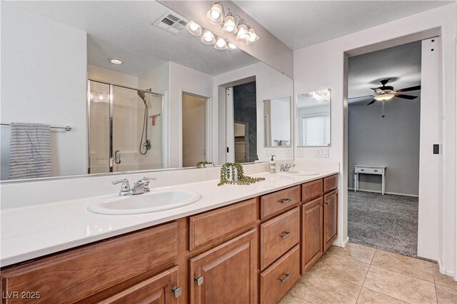 7704 Lots Hills Dr, Las Vegas, NV 89179 - full bathroom featuring double vanity, tile patterned floors, a shower stall, and a ceiling fan