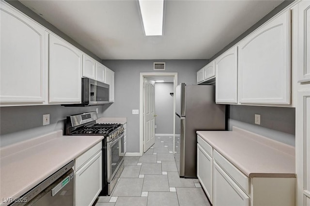 198 Winterport St, Henderson, NV 89074 - kitchen featuring stainless steel appliances, white cabinetry, light tile patterned flooring, and light countertops