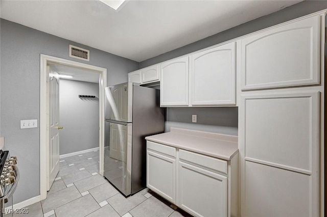 198 Winterport St, Henderson, NV 89074 - kitchen with appliances with stainless steel finishes, white cabinetry, light tile patterned floors, and light countertops