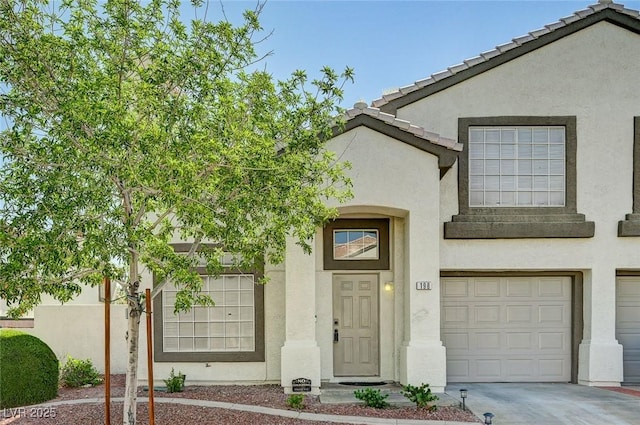 198 Winterport St, Henderson, NV 89074 - view of front of house with stucco siding, driveway, and an attached garage