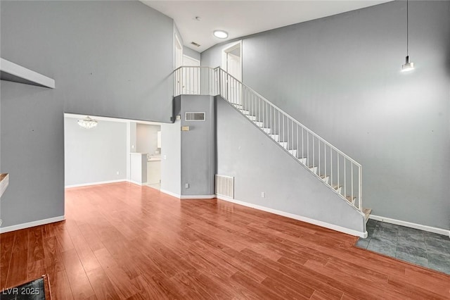 198 Winterport St, Henderson, NV 89074 - unfurnished living room with a towering ceiling, wood finished floors, and stairway