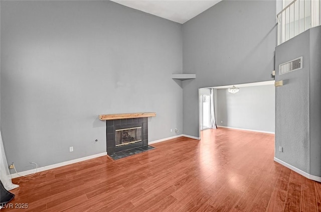 198 Winterport St, Henderson, NV 89074 - unfurnished living room with high vaulted ceiling, wood finished floors, and a fireplace