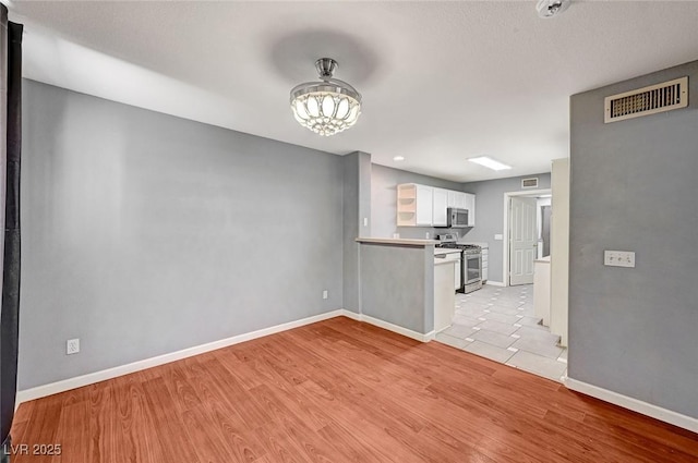 198 Winterport St, Henderson, NV 89074 - unfurnished living room with light wood-style floors and a chandelier
