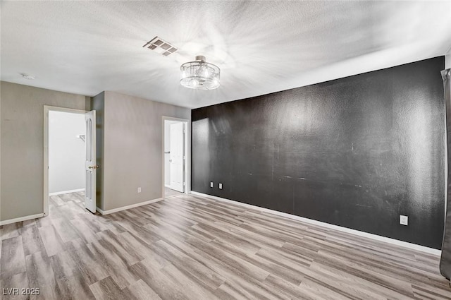 198 Winterport St, Henderson, NV 89074 - spare room featuring wood finished floors, a chandelier, a smoke detector, and a textured ceiling