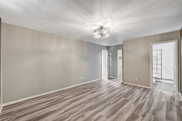 198 Winterport St, Henderson, NV 89074 - unfurnished room featuring wood finished floors, a chandelier, and a textured ceiling