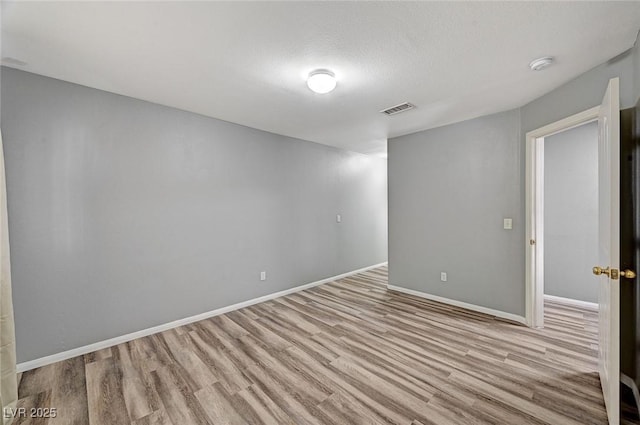 198 Winterport St, Henderson, NV 89074 - empty room with light wood-style flooring and a smoke detector