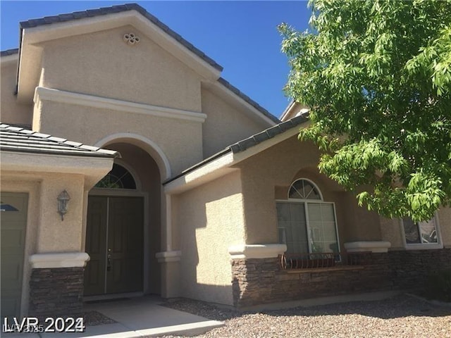 6245 Hawthorn Woods Ave, Las Vegas, NV 89130 - view of side of home featuring stone siding and stucco siding