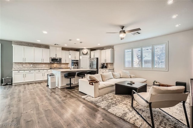 6233 Canterbury Field Rd, Las Vegas, NV 89113 - living room featuring ceiling fan, light wood-style flooring, and recessed lighting