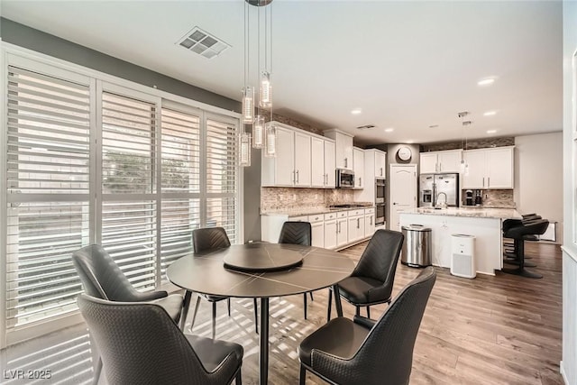 6233 Canterbury Field Rd, Las Vegas, NV 89113 - dining space featuring light wood-style flooring and recessed lighting