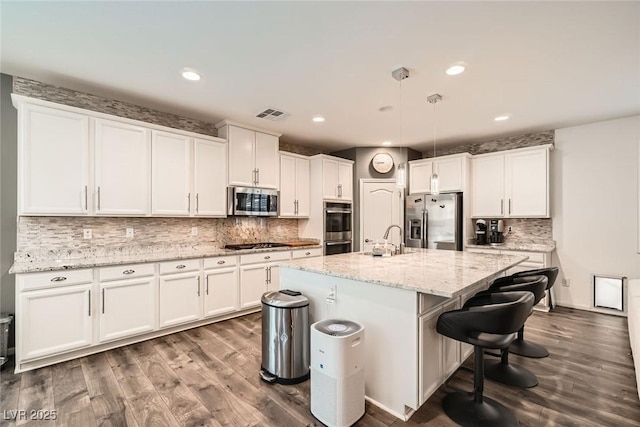 6233 Canterbury Field Rd, Las Vegas, NV 89113 - kitchen featuring appliances with stainless steel finishes, dark wood-style flooring, white cabinetry, backsplash, and recessed lighting