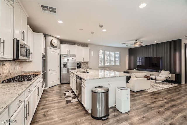 6233 Canterbury Field Rd, Las Vegas, NV 89113 - kitchen featuring stainless steel appliances, open floor plan, recessed lighting, a ceiling fan, and wood finished floors