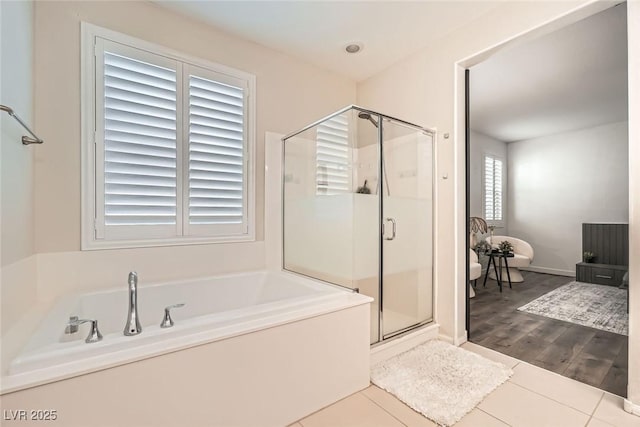 6233 Canterbury Field Rd, Las Vegas, NV 89113 - bathroom featuring a garden tub, a shower stall, and tile patterned flooring