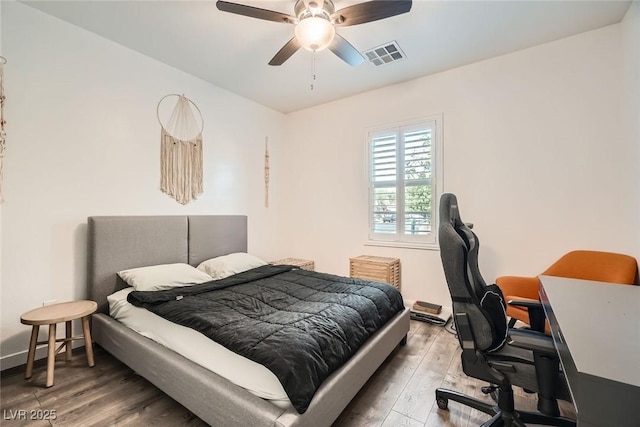 6233 Canterbury Field Rd, Las Vegas, NV 89113 - bedroom with wood finished floors, a desk, and ceiling fan