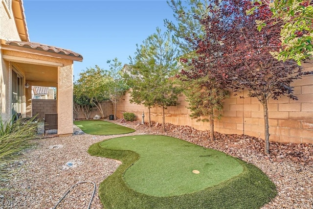 6233 Canterbury Field Rd, Las Vegas, NV 89113 - fenced backyard featuring a putting green