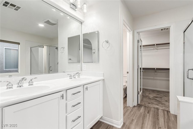 9006 Cedar Door Ave, Las Vegas, NV 89148 - full bath with a shower stall, wood finished floors, double vanity, and a spacious closet