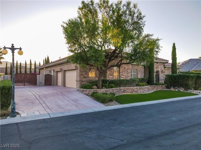 6120 Kings Brook Ct, Las Vegas, NV 89149 - view of front facade featuring a garage, driveway, a gate, and stone siding