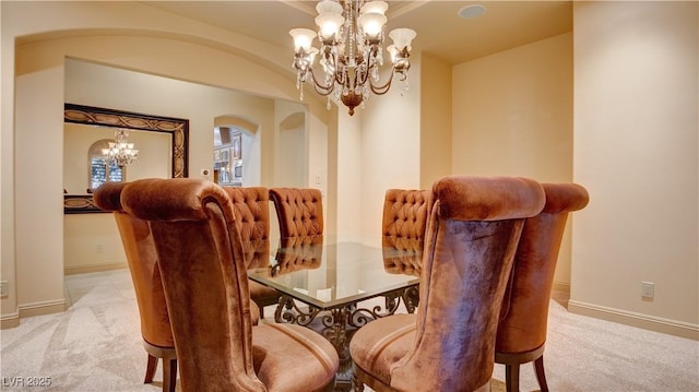 6120 Kings Brook Ct, Las Vegas, NV 89149 - dining space featuring a chandelier, light colored carpet, and arched walkways
