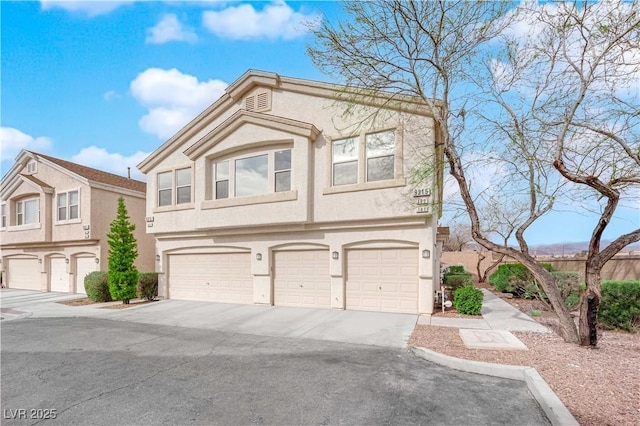 9315 Indian Corn Ct Unit 101, Las Vegas, NV 89178 - multi unit property with asphalt driveway, stucco siding, and an attached garage